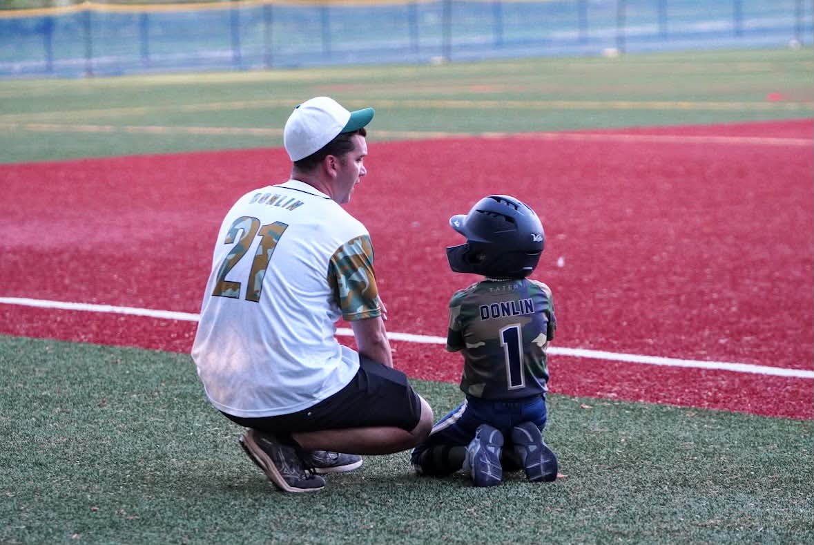 Coach Donlin and a young Aviator taking in the game