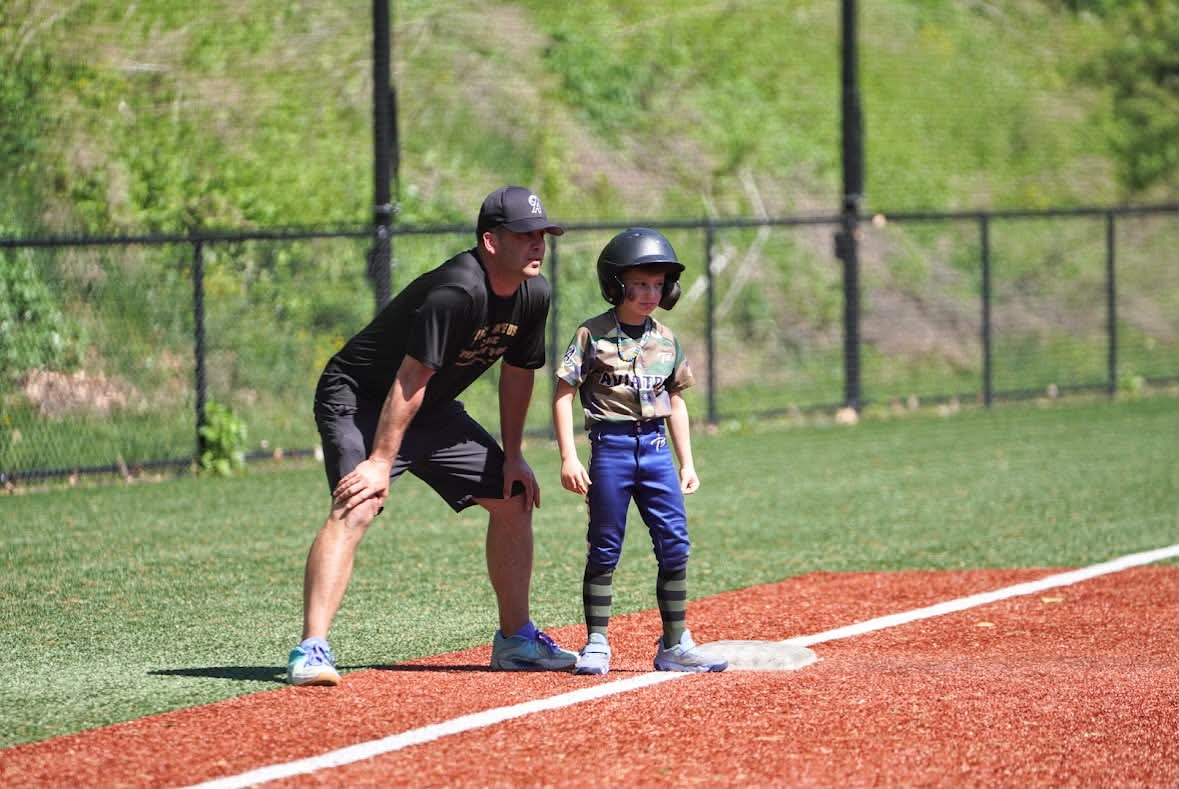 Coach Donlin coaching a young Aviator on the base paths