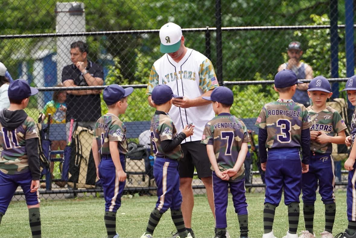 Coach Donlin with a huddle of young Aviators