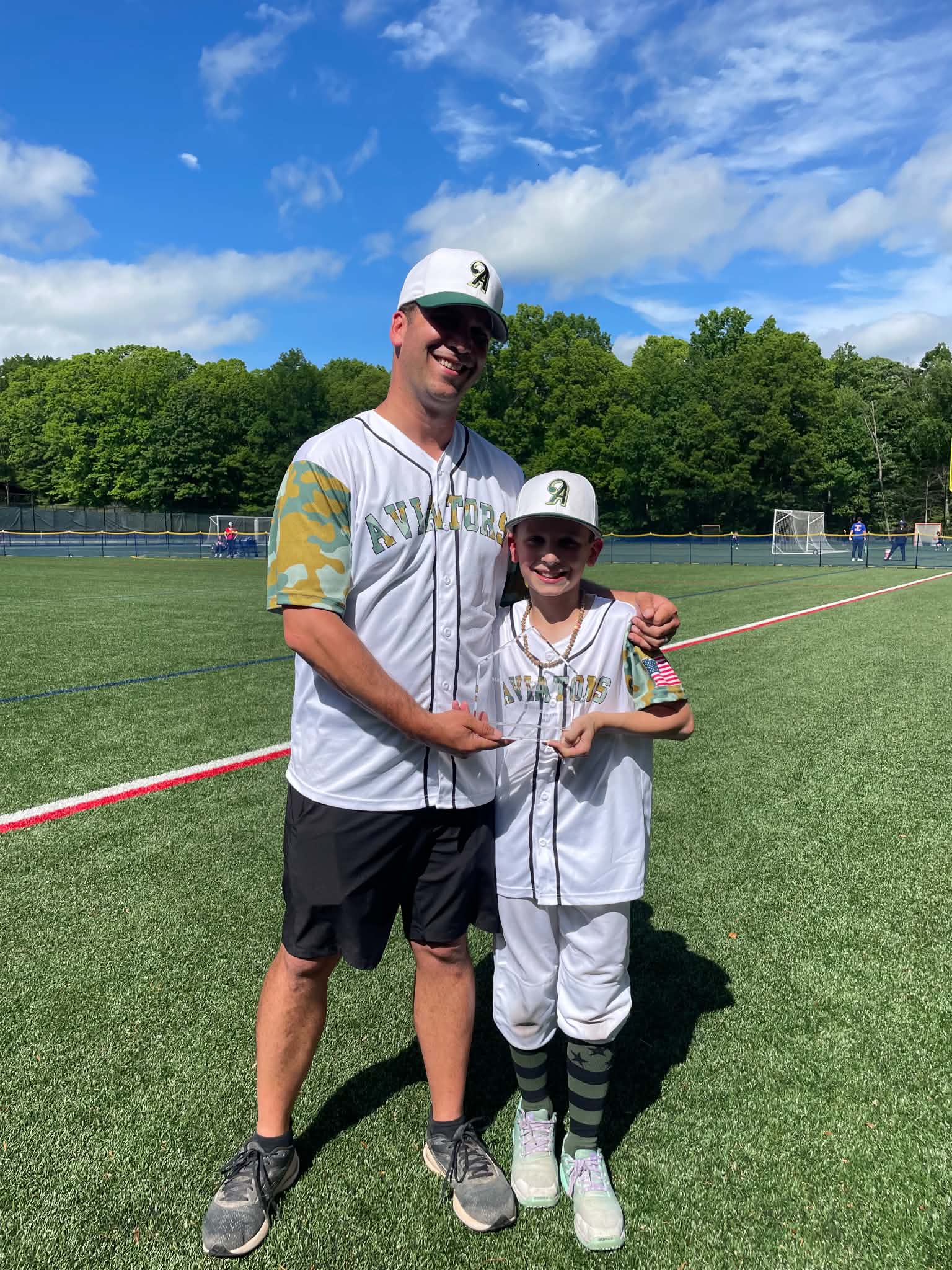 Coach Donlin with a player and their award
